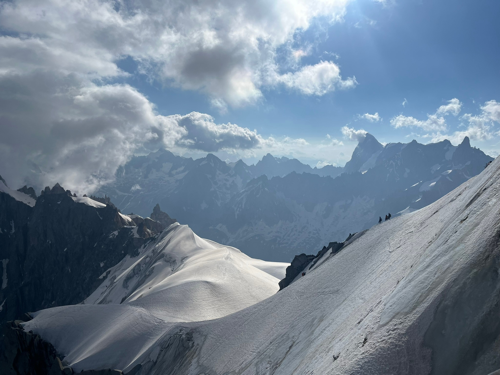 Snow-covered mountain ridges beneath a blue sky